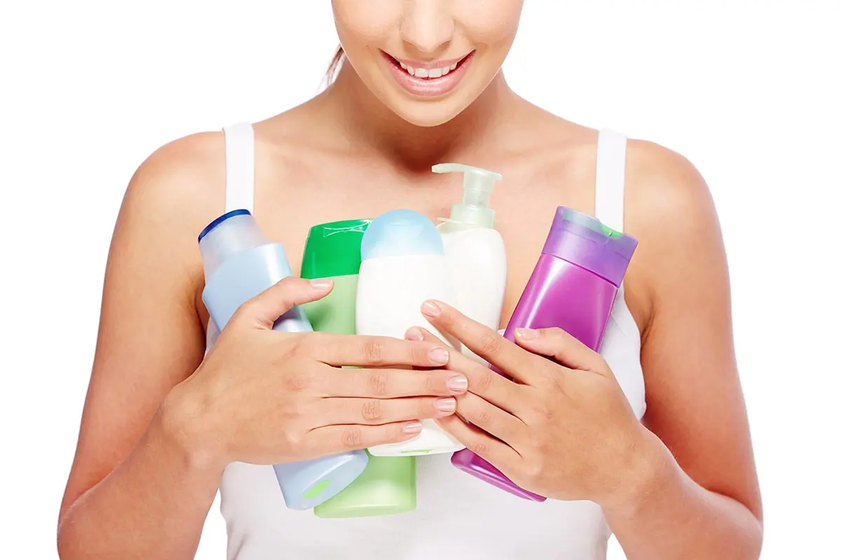 woman holding different lotions min